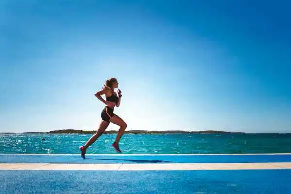 Woman running showing strong leg muscle Malvern Link
